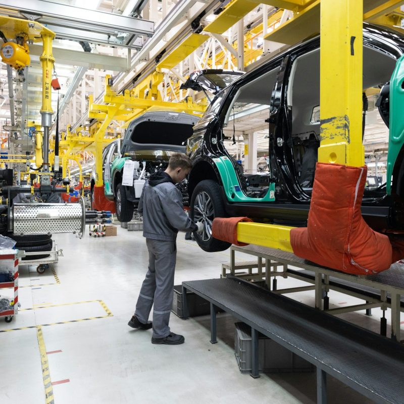 Car bodies are on assembly line. Factory for production of cars. Modern automotive industry. A car